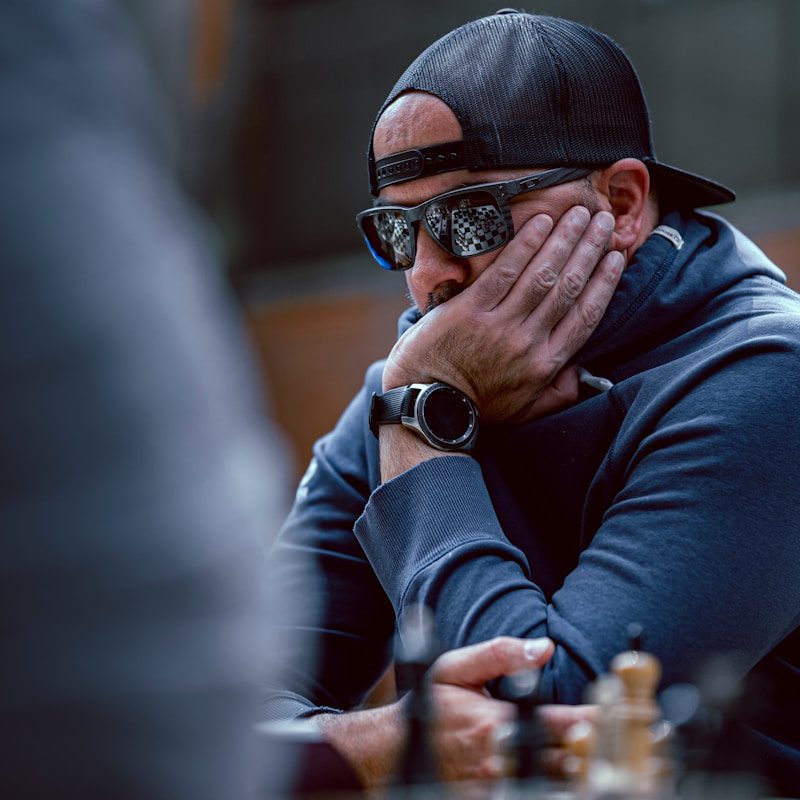 a man sitting at a table with his hands on his face